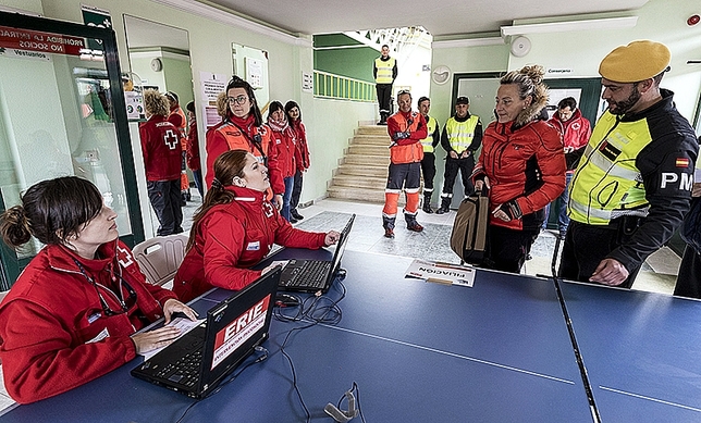 Personal de la Cruz Roja recibe en el albergue a los damnificados. 
